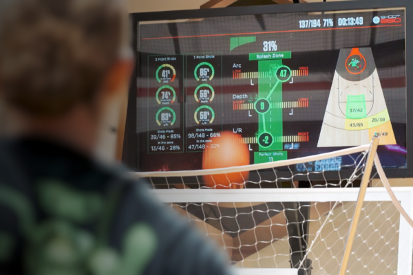 Basketball player viewing detailed shooting analytics and performance metrics on a Shoot 360 training screen.
